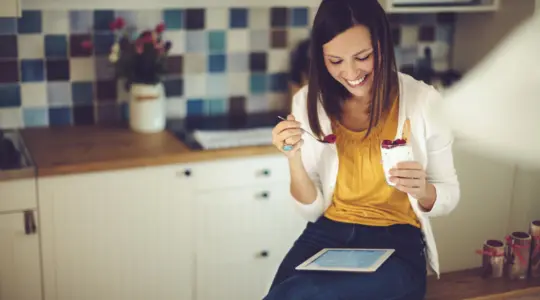 Woman eating healthy snack at work