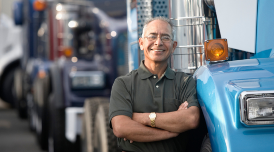 man-leaning-on-semi-truck