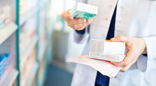 pharmacist-holding-prescriptions