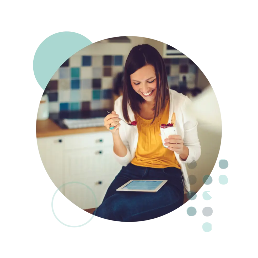 Woman eating healthy snack at work